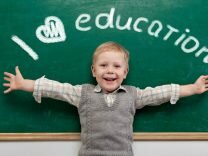Cheerful smiling child at the blackboard. School concept